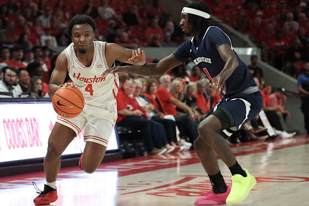 Houston Cougars guard L.J. Cryer (4) drives against Jackson State guard Dorian McMillian (1).