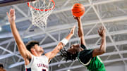 Grayson Rams guard Caleb Holt (3) makes an acrobatic lay up attempt while being guarded by Columbus Explorers guard Cayden Boozer (2) during the first quarter of a City of Palms Classic quarterfinal game at Suncoast Credit Union Arena in Fort Myers, Fla., on Friday, Dec. 20, 2024.