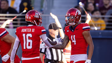 Nov 30, 2024; Tucson, Arizona, USA; Arizona Wildcats wide receiver Tetairoa McMillan (4) celebrates a touchdown with teammate Chris Hunter (16) against the Arizona State Sun Devils in the second half during the Territorial Cup at Arizona Stadium. Mandatory Credit: Mark J. Rebilas-Imagn Images