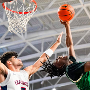 Grayson Rams guard Caleb Holt (3) makes an acrobatic lay up attempt while being guarded by Columbus Explorers guard Cayden Boozer (2) during the first quarter of a City of Palms Classic quarterfinal game at Suncoast Credit Union Arena in Fort Myers, Fla., on Friday, Dec. 20, 2024.
