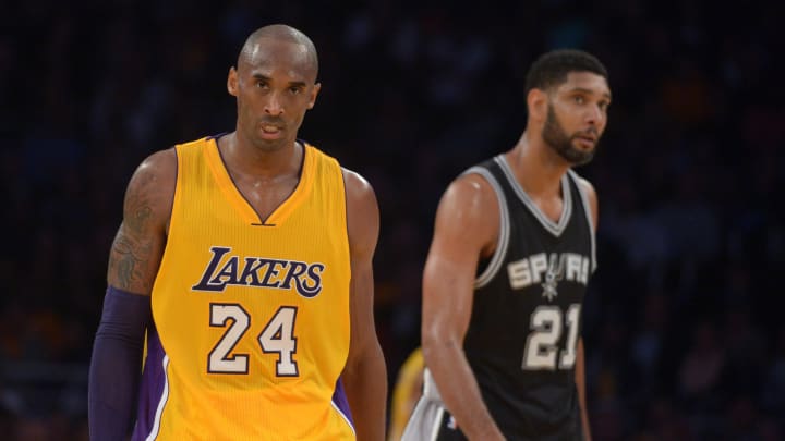 Nov 14, 2014; Los Angeles, CA, USA; Los Angeles Lakers guard Kobe Bryant (24) and San Antonio Spurs forward Tim Duncan (21) react at Staples Center. The Spurs defeated the Lakers 93-80. Mandatory Credit: Kirby Lee-USA TODAY Sports

