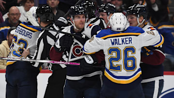 Jan 31, 2025; Denver, Colorado, USA; Colorado Avalanche defenseman Devon Toews (7) St. Louis Blues left wing Nathan Walker (26) and other players have to be separated after the whistle during the first period at Ball Arena. Mandatory Credit: Christopher Hanewinckel-Imagn Images