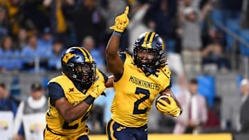 West Virginia Mountaineers safety Aubrey Burks (2) celebrates with safety Marcis Floyd (24) after intercepting the ball in the end zone in the first quarter of the 2023 Duke's Mayo Bowl.