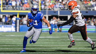 Seattle Seahawks wide receiver Jaxon Smith-Njigba carries the ball after a catch while chased by Cleveland Browns safety Grant Delpit 