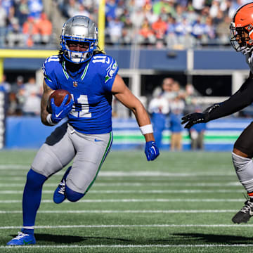 Seattle Seahawks wide receiver Jaxon Smith-Njigba carries the ball after a catch while chased by Cleveland Browns safety Grant Delpit 