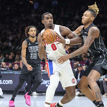 Nov 7, 2025; Brooklyn, New York, USA;  Detroit Pistons center Jalen Duren (0) looks to drive past Brooklyn Nets forward Noah Clowney (21) in the second quarter at Barclays Center. Mandatory Credit: Wendell Cruz-Imagn Images