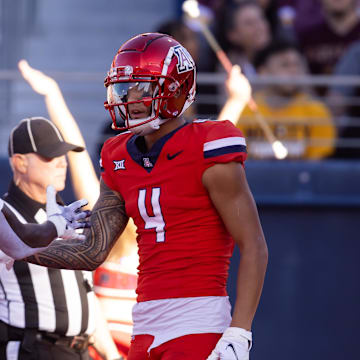 Nov 30, 2024; Tucson, Arizona, USA; Arizona Wildcats wide receiver Tetairoa McMillan (4) celebrates a touchdown with teammate Chris Hunter (16) against the Arizona State Sun Devils in the second half during the Territorial Cup at Arizona Stadium. Mandatory Credit: Mark J. Rebilas-Imagn Images