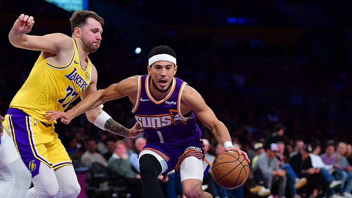 Phoenix Suns guard Devin Booker (1) moves to the basket against Los Angeles Lakers guard Luka Doncic (77) during the first half at Crypto.com Arena.