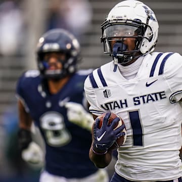 Sep 30, 2023; East Hartford, Connecticut, USA; Utah State Aggies wide receiver Jalen Royals (1) runs the ball for a touchdown against the UConn Huskies in the second half at Rentschler Field at Pratt & Whitney Stadium. Mandatory Credit: David Butler II-Imagn Images
