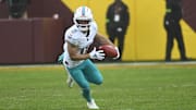 Dec 3, 2023; Landover, Maryland, USA; Miami Dolphins wide receiver Braxton Berrios (0) returns a punt against the Washington Commanders during the second half at FedExField. Mandatory Credit: Brad Mills-Imagn Images
