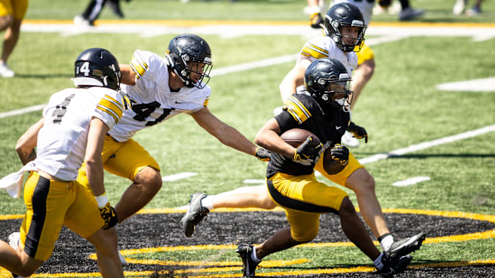 Apr 26, 2025; Iowa City, IA, USA; Iowa running back Kamari Moulton (28) gets tackled by Iowa linebacker Jaden Harrell (41) during a spring NCAA football open practice at Kinnick Stadium. Mandatory Credit: Joseph Cress/For the Register