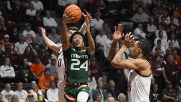 Feb 21, 2023; Blacksburg, Virginia, USA; Miami (Fl) Hurricanes guard Nijel Pack (24) drives past Virginia Tech Hokies guard Hunter Cattoor (0) and Virginia Tech Hokies center Lynn Kidd (15) in the first half at Cassell Coliseum. Mandatory Credit: Lee Luther Jr.-USA TODAY Sports