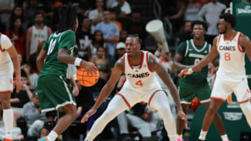 Nov 3, 2025; Coral Gables, Florida, USA; Miami Hurricanes guard Marcus Allen (4) defends against Jacksonville Dolphins guard Simon Wheeler (10) during the first half at Watsco Center. Mandatory Credit: Sam Navarro-Imagn Images