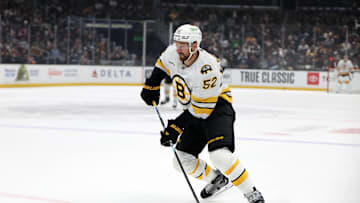 Nov 21, 2025; Los Angeles, California, USA;  Boston Bruins center Sean Kuraly (52) skates with the puck during the first period against the Los Angeles Kings at Crypto.com Arena. Mandatory Credit: Kiyoshi Mio-Imagn Images