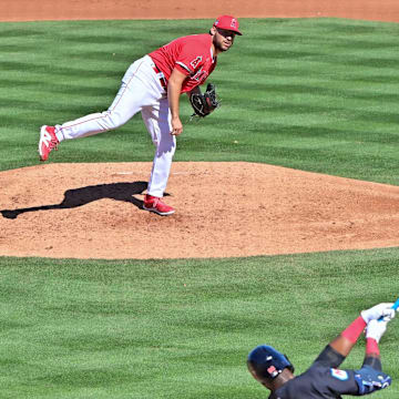 Angels starting pitcher Chase Silseth (63) throws to Cleveland Guardians right fielder Estevan Florial (90) in the fourth inning during a spring training game at Tempe Diablo Stadium on Feb. 29, 2024.