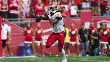Sep 20, 2025; Madison, Wisconsin, USA;  Maryland Terrapins' Malik Washington (7) scrambles with the football during the second quarter against the Wisconsin Badgers at Camp Randall Stadium. Mandatory Credit: Jeff Hanisch-Imagn Images