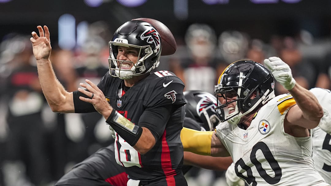 Sep 8, 2024; Atlanta, Georgia, USA; Pittsburgh Steelers linebacker T.J. Watt (90) strips the ball from Atlanta Falcons quarterback Kirk Cousins (18) at Mercedes-Benz Stadium. Mandatory Credit: Dale Zanine-Imagn Images