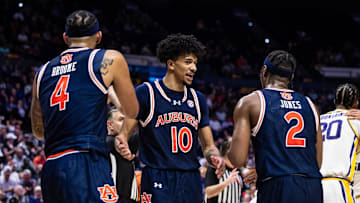 Jan 29, 2025; Baton Rouge, Louisiana, USA;  Auburn Tigers guard Chad Baker-Mazara (10) and guard Denver Jones (2) and forward Johni Broome (4) looks on again LSU Tigers forward Derek Fountain (20) during the second half at Pete Maravich Assembly Center. Mandatory Credit: Stephen Lew-Imagn Images