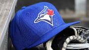 Apr 16, 2025; Toronto, Ontario, CAN; A Toronto Blue Jays hat and glove in the dugout during a game against the Atlanta Braves at Rogers Centre. 