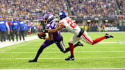 Jan 15, 2023; Minneapolis, Minnesota, USA; Minnesota Vikings wide receiver Justin Jefferson (18) runs with the ball after making a catch while defended by New York Giants cornerback Adoree' Jackson (22) during the first quarter of a wild card game at U.S. Bank Stadium.