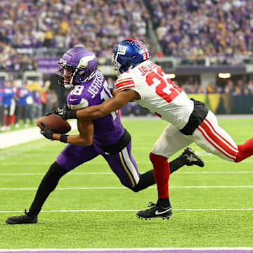 Jan 15, 2023; Minneapolis, Minnesota, USA; Minnesota Vikings wide receiver Justin Jefferson (18) runs with the ball after making a catch while defended by New York Giants cornerback Adoree' Jackson (22) during the first quarter of a wild card game at U.S. Bank Stadium.