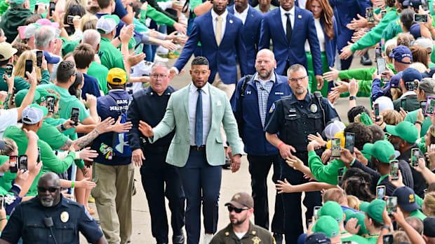 Notre Dame head coach Marcus Freeman leads the team into the stadium