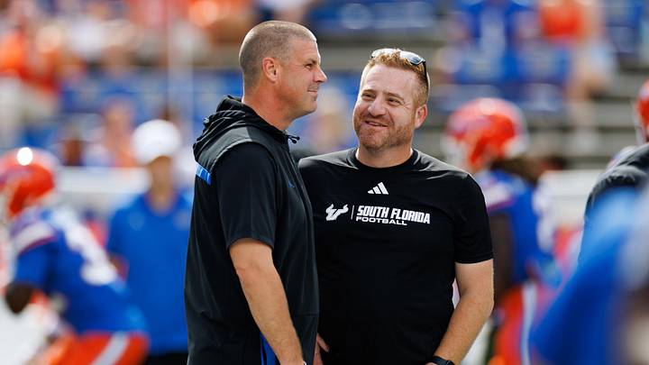 Sep 6, 2025; Gainesville, Florida, USA; Florida Gators head coach Billy Napier and South Florida Bulls head coach Alex Golesh talk before the game at Ben Hill Griffin Stadium. Mandatory Credit: Matt Pendleton-Imagn Images