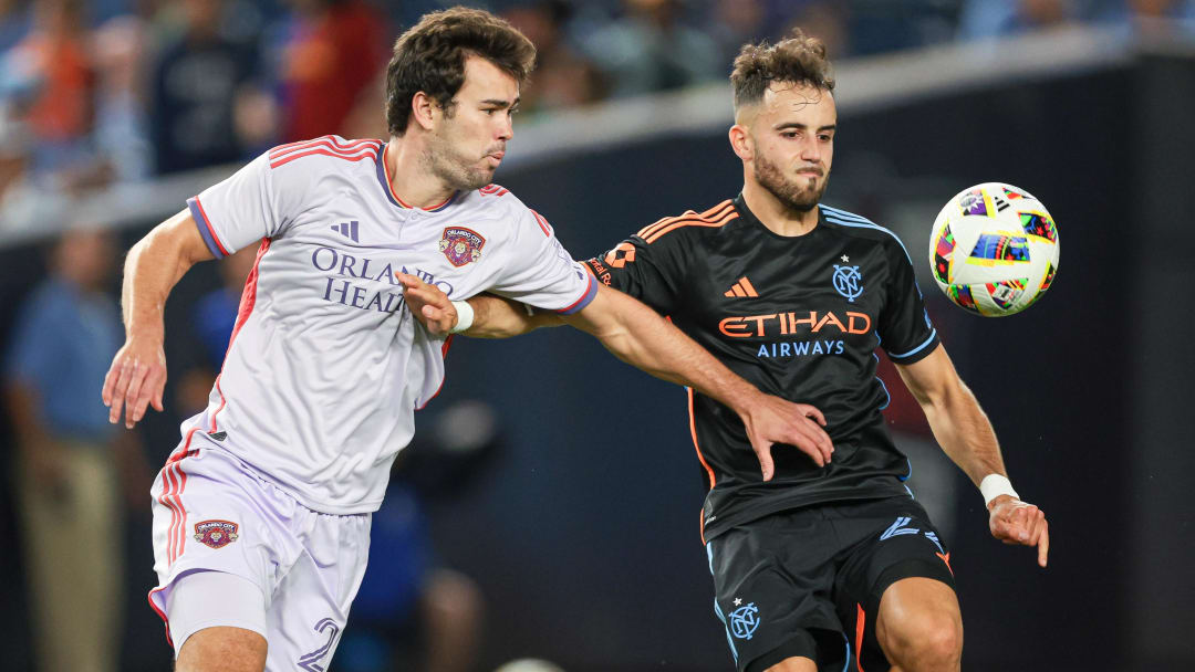 Jun 28, 2024; Bronx, New York, USA; Orlando City forward Jack Lynn (27) battles New York City FC forward Kevin O'Toole (22) for the ball during the second half at Yankee Stadium. Mandatory Credit: Vincent Carchietta-USA TODAY Sports