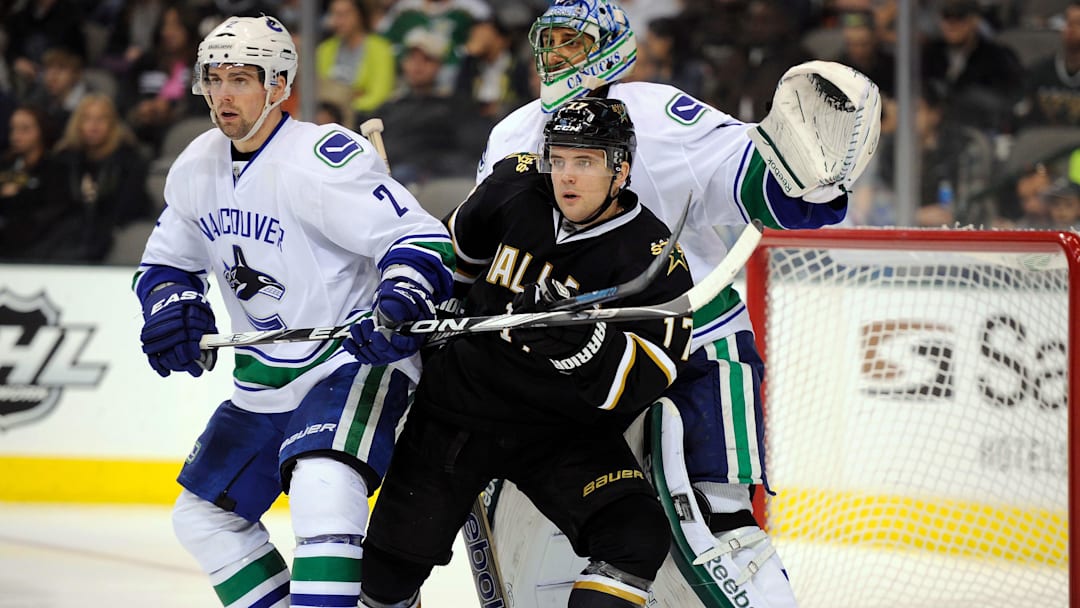 Feb 26, 2012; Dallas, TX, USA; Dallas Stars center Toby Petersen (17) screens Vancouver Canucks goalie Roberto Luongo (1) as left wing David Booth (7) defends during the second period at the American Airlines Center. Mandatory Credit: Jerome Miron-Imagn Images
