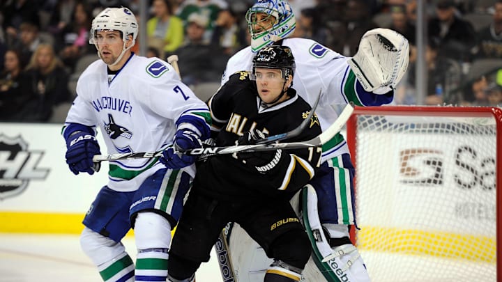 Feb 26, 2012; Dallas, TX, USA; Dallas Stars center Toby Petersen (17) screens Vancouver Canucks goalie Roberto Luongo (1) as left wing David Booth (7) defends during the second period at the American Airlines Center. Mandatory Credit: Jerome Miron-Imagn Images