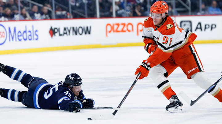 Anaheim Ducks forward Leo Carlsson (91) skates around Winnipeg Jets forward Cole Koepke (45) during the third period at Canada Life Centre. 