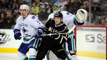 Feb 26, 2012; Dallas, TX, USA; Dallas Stars center Toby Petersen (17) screens Vancouver Canucks goalie Roberto Luongo (1) as left wing David Booth (7) defends during the second period at the American Airlines Center. Mandatory Credit: Jerome Miron-Imagn Images