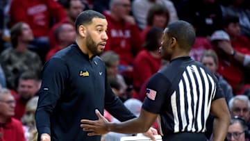 Loyola Chicago head coach Drew Valentine argues with an official as the Ramblers battle the Bradley Braves in the first half of their first-round NIT basketball game Wednesday, March 20, 2024 at Carver Arena.
