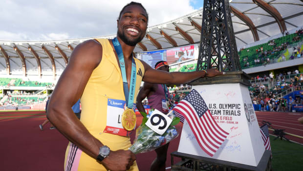 Noah Lyles poses with a replica Eiffel Tower after qualifying for the Paris Olympics in the 200-meter dash.