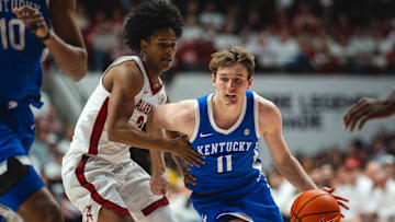 Feb 22, 2025; Tuscaloosa, Alabama, USA; Kentucky Wildcats guard Travis Perry (11) drives the ball against Alabama Crimson Tide guard Aden Holloway (2) during the second half at Coleman Coliseum. Mandatory Credit: Will McLelland-Imagn Images