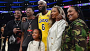 Los Angeles Lakers forward LeBron James (6) poses for photos with his sons Bronny and Bryce Maximus, daughter Zhuri, wife Savannah and mother Gloria after the game against the Oklahoma City Thunder at Crypto.com Arena.