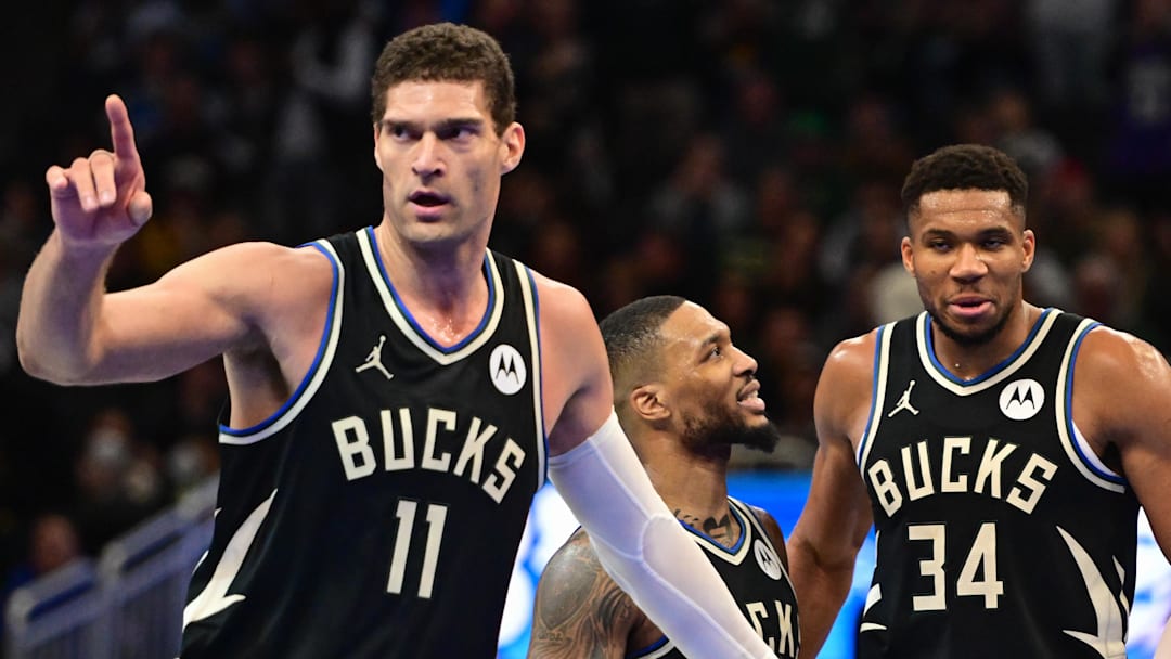 Nov 22, 2024; Milwaukee, Wisconsin, USA; Milwaukee Bucks center Brook Lopez (11), guard Damian Lillard (0) and forward Giannis Antetokounmpo (34) celebrate near the end of the game against the Indiana Pacers at Fiserv Forum. Mandatory Credit: Benny Sieu-Imagn Images