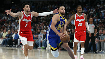 Apr 1, 2025; Memphis, Tennessee, USA; Golden State Warriors guard Stephen Curry (30) drives to the basket between Memphis Grizzlies guard Scotty Pippen Jr. (1) and guard Ja Morant (12) during the fourth quarter at FedExForum. Mandatory Credit: Petre Thomas-Imagn Images