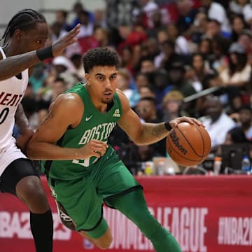 Jul 9, 2022; Las Vegas, NV, USA; Boston Celtics guard Brodric Thomas (97) dribbles against Miami Heat guard Marcus Garrett (0) during an NBA Summer League game at Cox Pavilion. Mandatory Credit: Stephen R. Sylvanie-Imagn Images