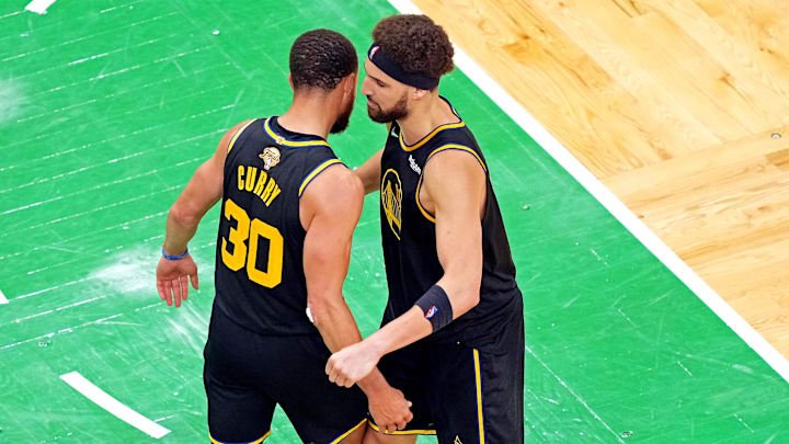 Golden State Warriors guards Stephen Curry (30) and Klay Thompson (11) react after beating the Boston Celtics during game four of the 2022 NBA Finals at TD Garden.