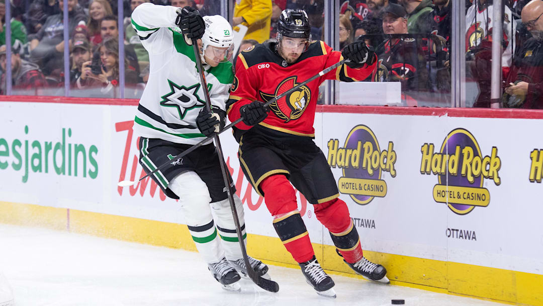 Nov 11, 2025; Ottawa, Ontario, CAN; Dallas Stars defenseman Esa Lindell (23) battles for control of the puck with  Ottawa Senators right wing Drake Batherson (19)  in the first period at the Canadian Tire Centre. Mandatory Credit: Marc DesRosiers-IMAGN Images