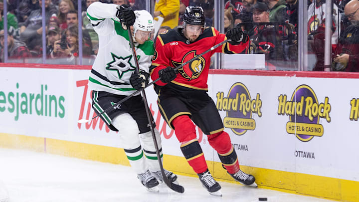 Nov 11, 2025; Ottawa, Ontario, CAN; Dallas Stars defenseman Esa Lindell (23) battles for control of the puck with  Ottawa Senators right wing Drake Batherson (19)  in the first period at the Canadian Tire Centre. Mandatory Credit: Marc DesRosiers-IMAGN Images