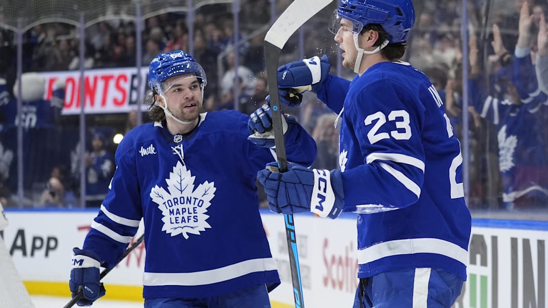 Dec 27, 2025; Toronto, Ontario, CAN; Toronto Maple Leafs forward Matias Maccelli (63) congratulates forward Matthew Knies (23) after his goal against the Ottawa Senators during the third period at Scotiabank Arena. Mandatory Credit: John E. Sokolowski-Imagn Images