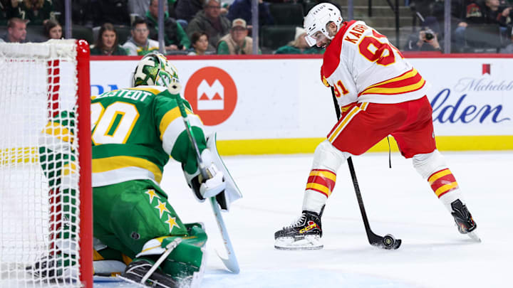 Nov 9, 2025; Saint Paul, Minnesota, USA; Calgary Flames center Nazem Kadri (91) shoots the puck against Minnesota Wild goaltender Jesper Wallstedt (30) during the third period at Grand Casino Arena. Mandatory Credit: Matt Krohn-Imagn Images