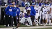 Oct 26, 2024; Manhattan, Kansas, USA; Kansas State Wildcats running back DJ Giddens (31) tries to run from Kansas Jayhawks cornerback Mello Dotson (3) during the fourth quarter at Bill Snyder Family Football Stadium. Mandatory Credit: Scott Sewell-Imagn Images