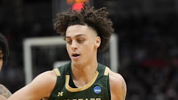 Mar 21, 2025; Seattle, WA, USA; Colorado State Rams guard Kyan Evans (0) drives the ball past Memphis Tigers guard PJ Haggerty (4) during the second half at Climate Pledge Arena. 