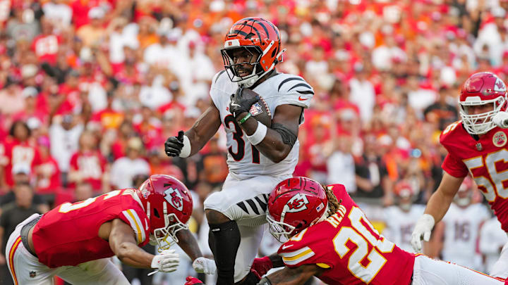 Sep 15, 2024; Kansas City, Missouri, USA; Cincinnati Bengals running back Zack Moss (31) runs the ball against Kansas City Chiefs defensive end George Karlaftis (56) and safety Justin Reid (20) during the second half at GEHA Field at Arrowhead Stadium. Mandatory Credit: Jay Biggerstaff-Imagn Images