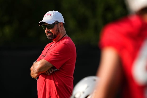 Head coach watches during practice.