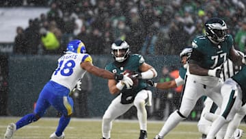 Jan 19, 2025; Philadelphia, Pennsylvania, USA; Philadelphia Eagles quarterback Jalen Hurts vs Los Angeles Rams linebacker Omar Speights. Mandatory Credit: Eric Hartline-Imagn Images