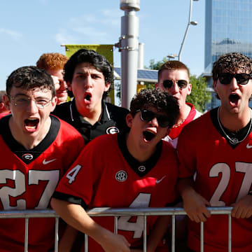 Georgia fans bark as Georgia arrives before the start of the NCAA Aflac Kickoff Game in Atlanta, on Saturday, Aug. 31, 2024.